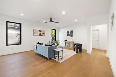 Living room featuring ceiling fan, recessed light