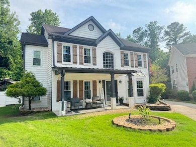 View of front of property featuring a porch, a front yard, and brick siding