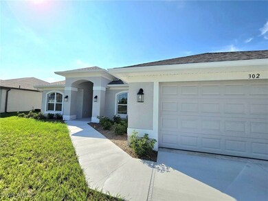 Ranch-style house featuring a front yard and a gar