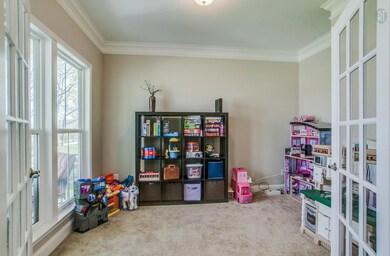 This is a great space to catch up with friends and family or read a book. Architectural details include crown molding and French doors for privacy.  This room is multi-functional and could also work well as a Study or Music Room .