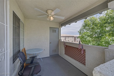 View of patio with a ceiling fan and a balcony