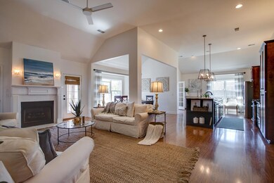 Both Modern and Warm, The Main Living Area Flows Beautifully from Room to Room! Ceiling Heights Reach 12 Feet! Natural Lights Fills this Space and Designer Fixtures and Recessed Lights Offer Additional Light and Style!  