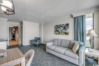Living room featuring carpet floors, ornamental mo