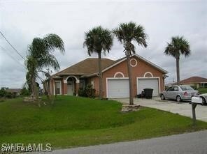 Ranch-style house with a front lawn, a garage, and