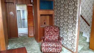 This view of the Dining Room shows the stairway to