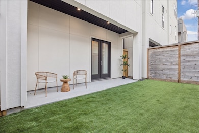 French doors open to a generously sized covered porch and a fenced yard, beautifully turfed for year-round enjoyment. Now, let’s step around to the front to admire the home’s impressive façade.