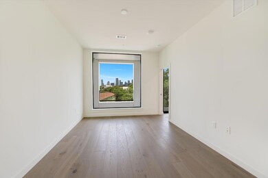Spare room with baseboards, wood finished floors,