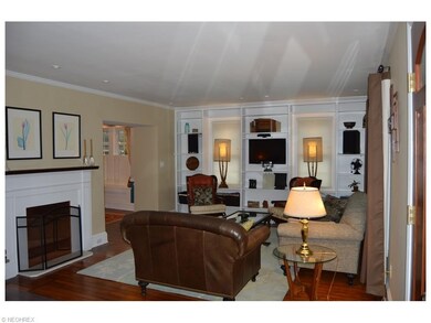 The living room with original hardwood floors is h