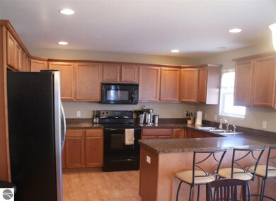 Look at this beautiful kitchen. With its peninsula, you'll have tons of counter space.  Gorgeous cherry cabinets for oodles of storage.   Room for 3 stools so your dinner guests can converse with you while you cook for the crowd.