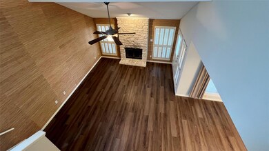 Unfurnished living room featuring a ceiling fan, 
