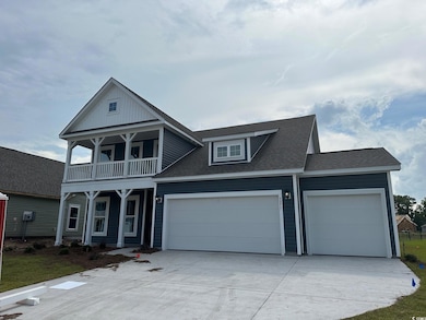 View of front facade with a balcony and a garage