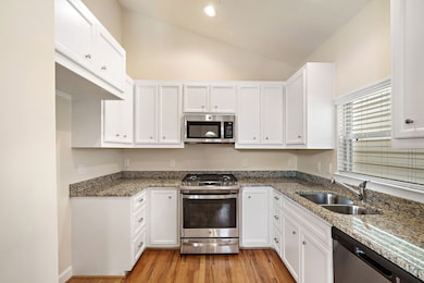 Another view of the granite countertops and kitchen area.
