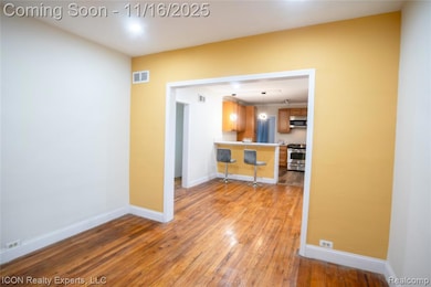 Unfurnished room with light wood-style floors and baseboards