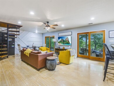 Living area with stairway, a decorative wall, lig