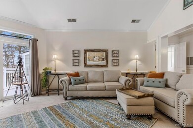 Carpeted living room with ornamental molding