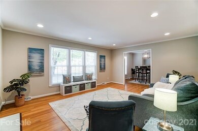 The living room is flooded by natural light from w