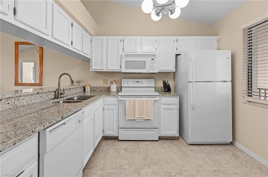 Kitchen with white cabinets, light tile patterned 