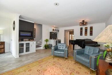 Open living area with wood-look porcelain tile flo
