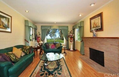 Living room features view windows, hardwood floors