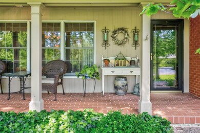 The covered brick front porch is nice place to sit in the quiet evening or greet your guests.