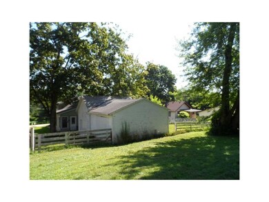 Exterior Back. View of the first garage and the ba