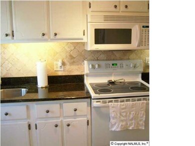 Updated Kitchen-white appliances-granite counter tops & tiled back splash