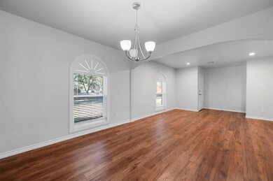 Spare room with arched walkways, hardwood / wood-s