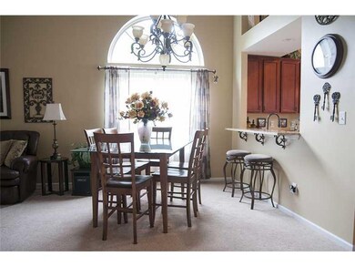 Dining Room. Dining room combination with the Great Room.  Large palladium window lets in lots of daylight.  Breakfast bar to the kitchen, granite countertop.