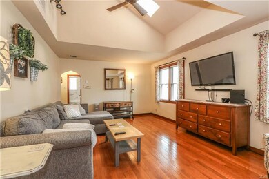 Into the Living Room with gleaming Hardwood!