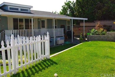Lawn area looking at coverd porch and entrance to 