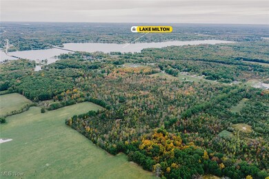 Aerial view of a heavily wooded area and a large body of water