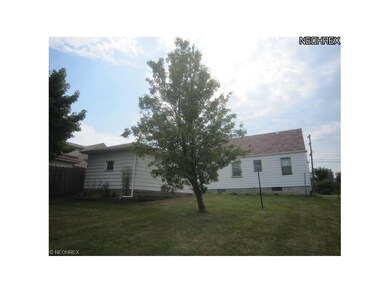 View of rear of house and garage on sloped, well d