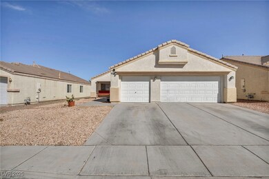 Ranch-style home featuring driveway, a tile roof,