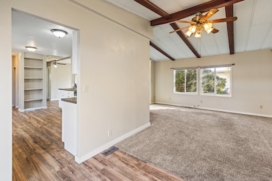 Empty room featuring a ceiling fan and light wood finished floors