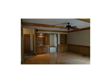 Elegant Family Room with wood beams & hardwood flo