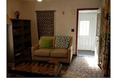 Living Room. The sunny front porch opens up to the