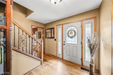 Entryway with light wood-style floors, plenty of natural light, and stairway