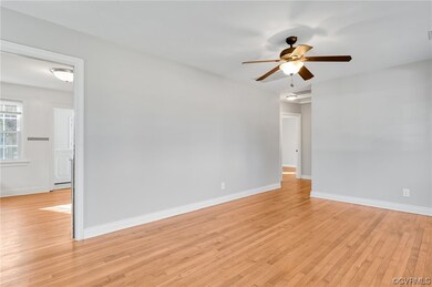 Family room with ceiling fan and light hardwood / wood-style floors