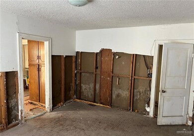 Unfurnished room with a textured ceiling