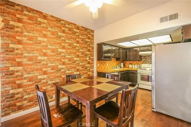 Spanish style kitchen counter top and back splash. Brick wall decorative wall paper.
