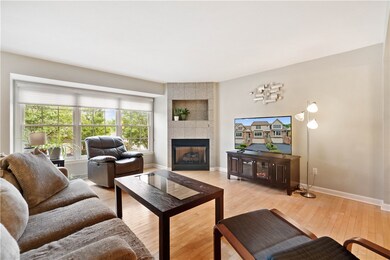 Gas fireplace and gleaming hardwood flooring.