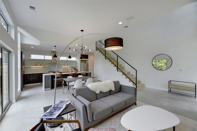 Living area featuring baseboards, recessed lighti