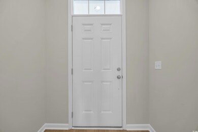Doorway to outside with baseboards and light wood 
