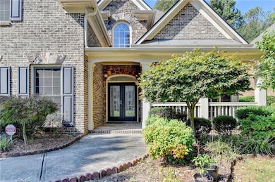Doorway to property featuring french doors and brick siding