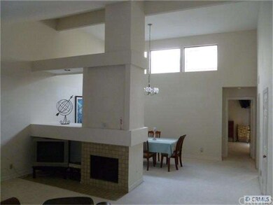 View of living room and dining room. Peek into mas