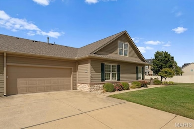 View of front facade with stone siding, roof with shingles, concrete driveway, and a garage