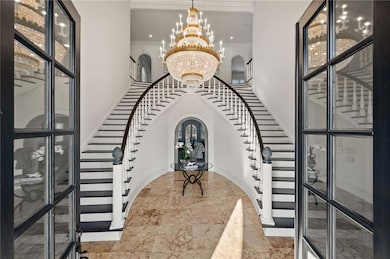 Sweeping grand entry with custom staircase