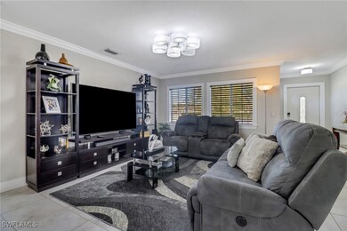 Tiled living room with ornamental molding, visible