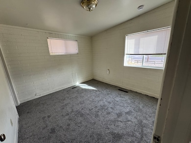 Carpeted empty room with healthy amount of natural light and lofted ceiling