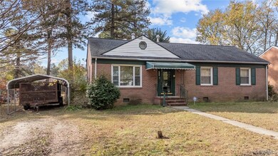 Bungalow-style home with a carport and a front law